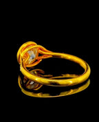 View of the open gallery and smooth yellow gold band structure on a 2 carat round lab diamond bezel ring