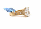 Side view showing geometric pattern engraving and bezel accent diamonds on yellow gold band of cushion lab diamond ring