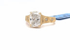 Perspective view highlighting the brilliance of a 3 CT elongated cushion cut lab diamond set on an intricately engraved gold ring