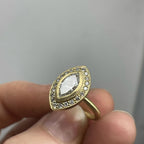 Close up detail of the intricate milgrain bezel and halo diamonds on a 3 CT marquise lab diamond ring
