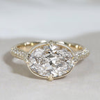 Top view of a 3 carat east west oval lab grown diamond ring with milgrain bezel frame