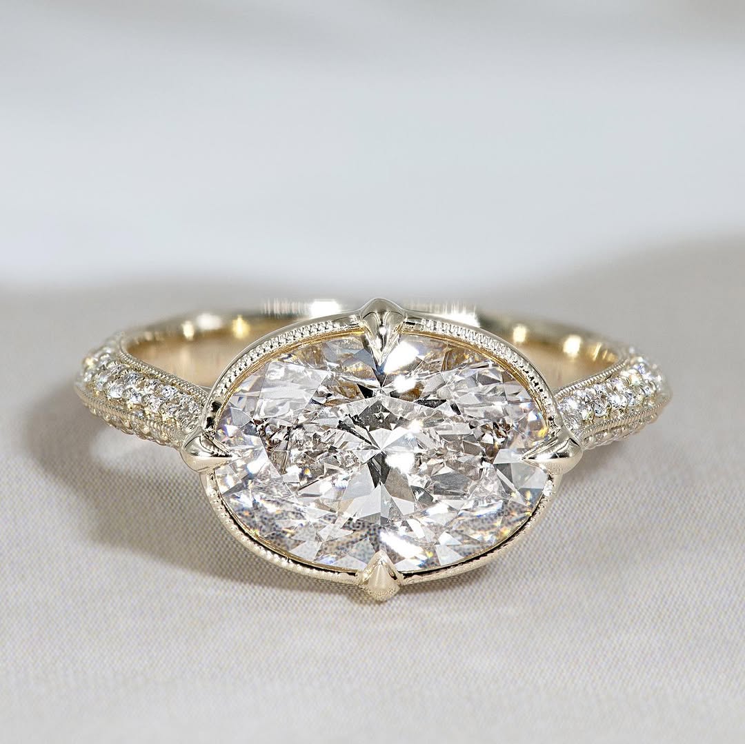 Top view of a 3 carat east west oval lab grown diamond ring with milgrain bezel frame