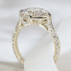 Detailed side profile of an east-west oval diamond ring showing the filigree basket and pave band