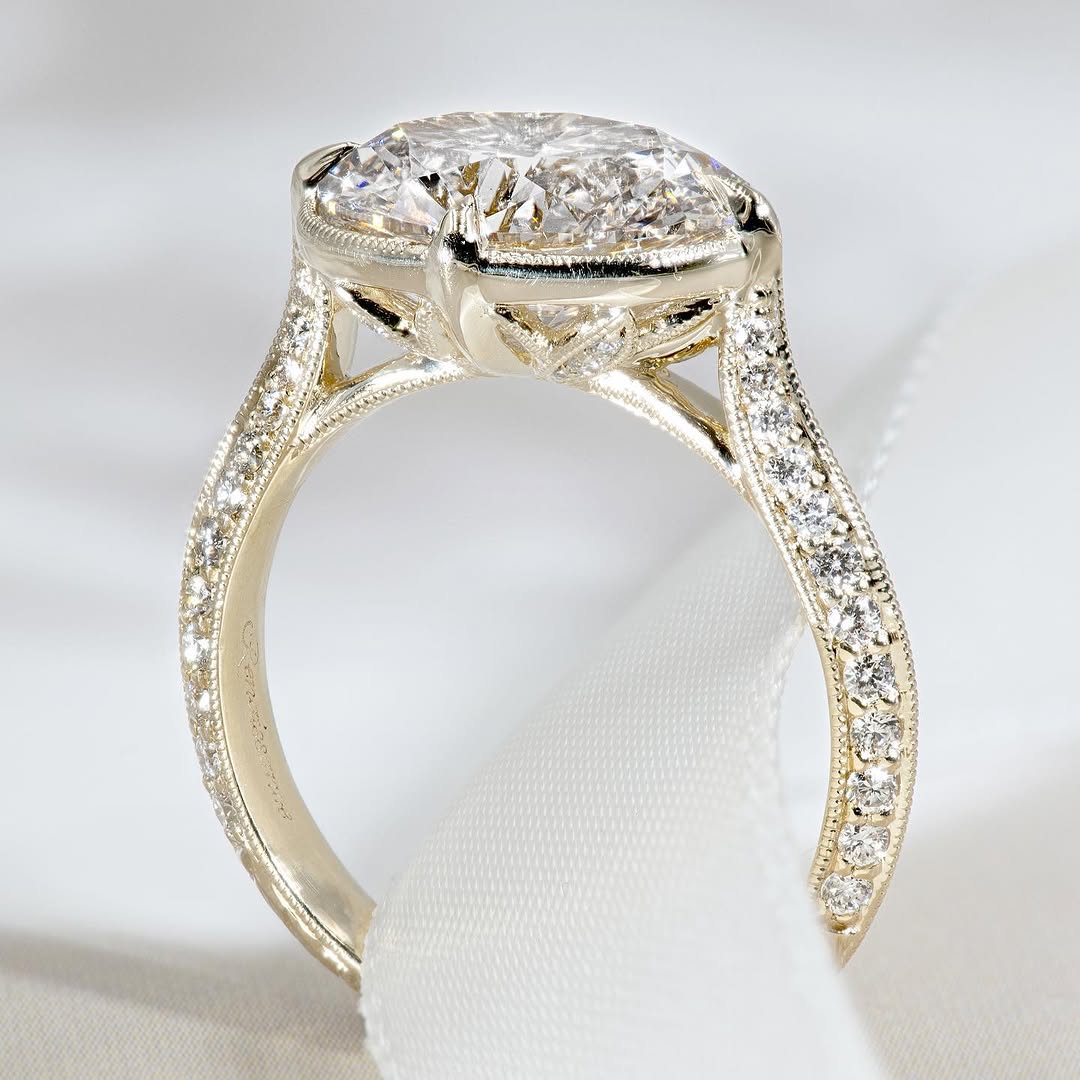 Detailed side profile of an east-west oval diamond ring showing the filigree basket and pave band