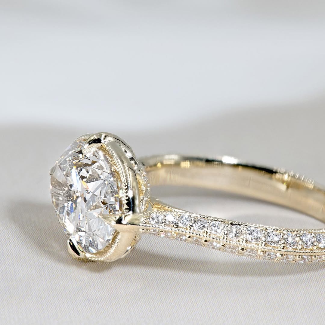 Close up side view of a 3ct oval lab diamond ring displaying the milgrain pave diamond band