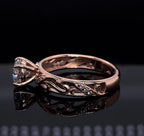 Side profile of 2 carat round lab diamond ring in rose gold showing filigree scrollwork band