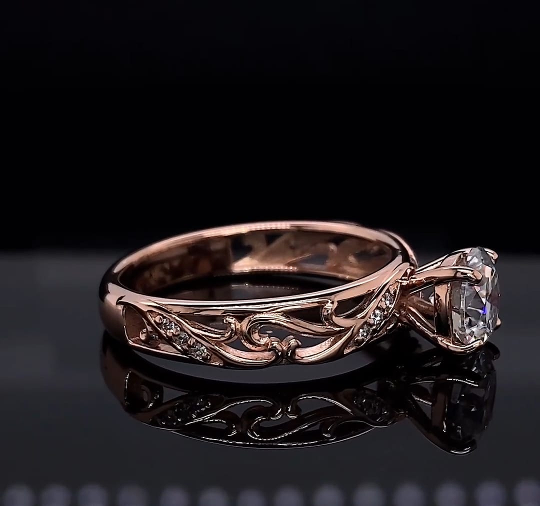 Side view highlight showing openwork vine filigree design on a rose gold lab diamond engagement ring