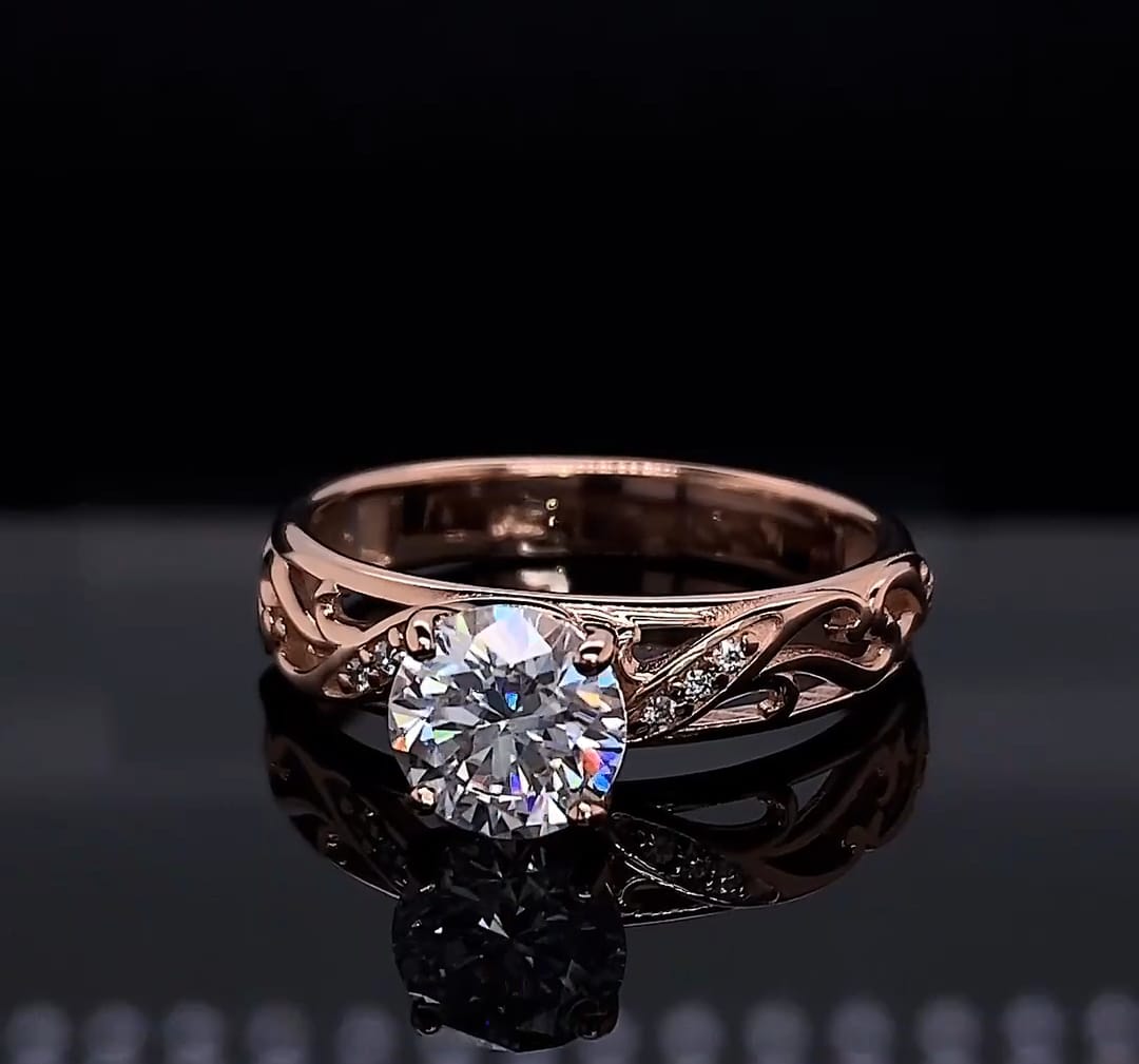 Close up front angle showing light refraction of a 2 carat round lab diamond in rose gold