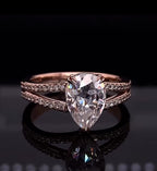 Front view of a 2 carat pear cut lab grown diamond ring with double row pave split shank in rose gold