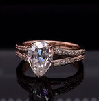 Close up shot showing the brilliant teardrop pear cut lab diamond in a rose gold split shank band