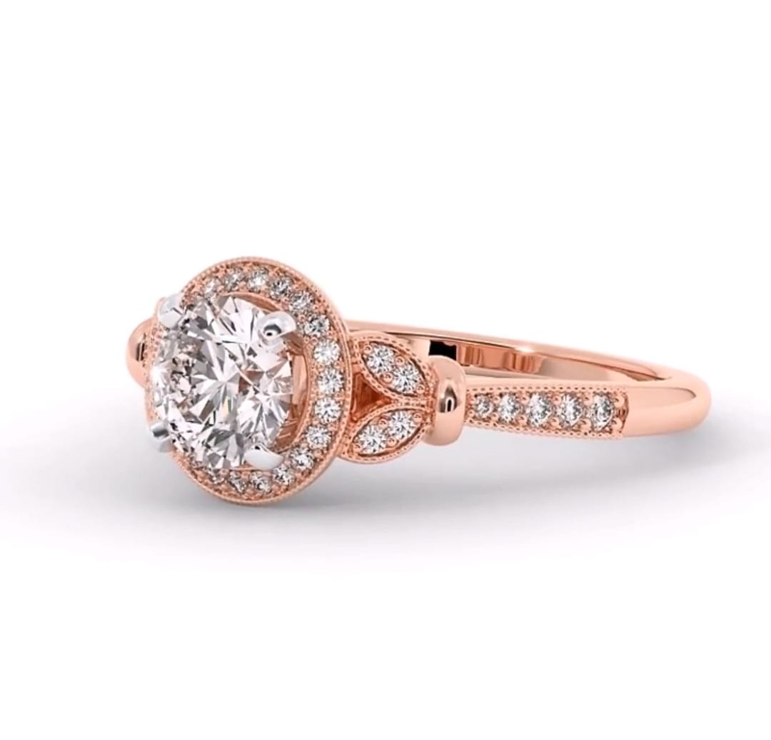 Angled front view of 3 CT round lab diamond ring featuring leaf side motifs and pave diamond halo in rose gold.