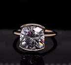 Front view of a 3 CT cushion cut lab grown diamond solitaire ring in a modern half-bezel gold setting.