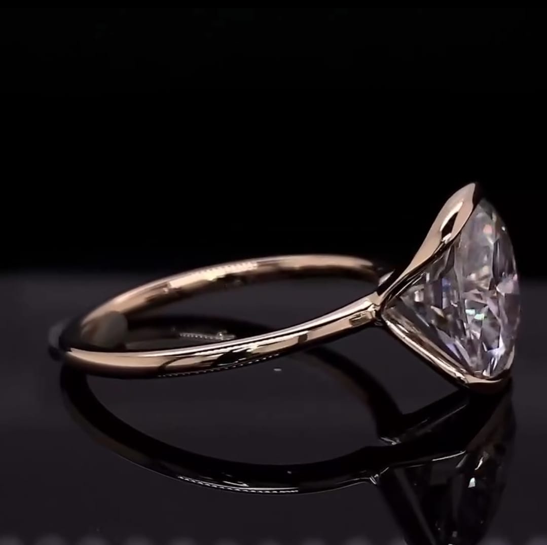 Side profile view of 3 carat cushion cut lab grown diamond ring displaying open sides and high polish band.