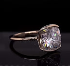 Three-quarter angle view showing the brilliance of a 3 CT cushion cut lab diamond in a half-bezel setting.