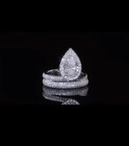 Front view of a 2 CT pear cut lab grown diamond ring with micro-pave halo and bypass band.