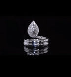 Direct reverse view of the intricate floral filigree pattern under the pear-shaped diamond setting.