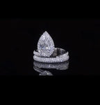 High-shine front angle of 2 CT pear lab grown diamond engagement ring on black reflective background.
