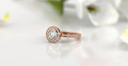 Perspective view of rose gold 2 CT round brilliant halo engagement ring