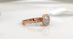 Side view highlighting the brilliant round center diamond and rose gold band
