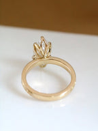Side profile of 3 carat marquise lab grown diamond ring showing unique floral basket setting in yellow gold