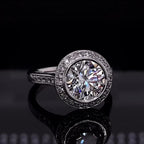Top down view of a 3 carat round cut lab grown diamond engagement ring with a bezel halo setting.