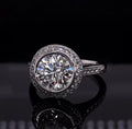 Close-up front view of a sparkling 3 carat round brilliant lab grown diamond in a delicate halo setting.