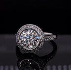 Close-up front view of a sparkling 3 carat round brilliant lab grown diamond in a delicate halo setting.