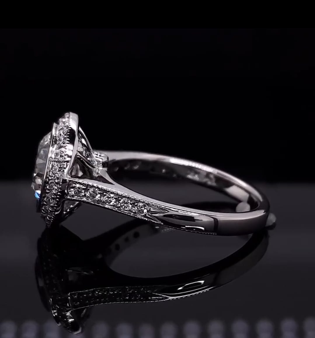 Profile view of a vintage-style bezel set diamond engagement ring highlighting the gallery and shoulder design.