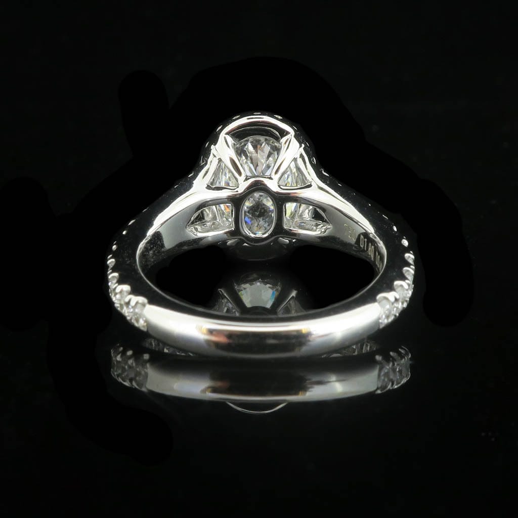 Under-gallery and back setting view of a 2 carat oval lab grown diamond engagement ring.
