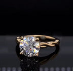 Close-up front perspective highlighting the brilliant facets of a 2 carat round lab diamond in a 4-prong yellow gold setting.