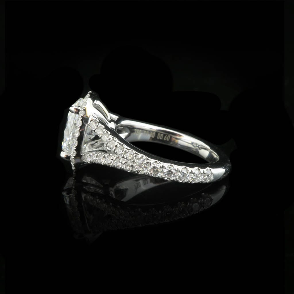 Angled side profile of a 2 CT oval halo diamond engagement ring showing band details on a black background.