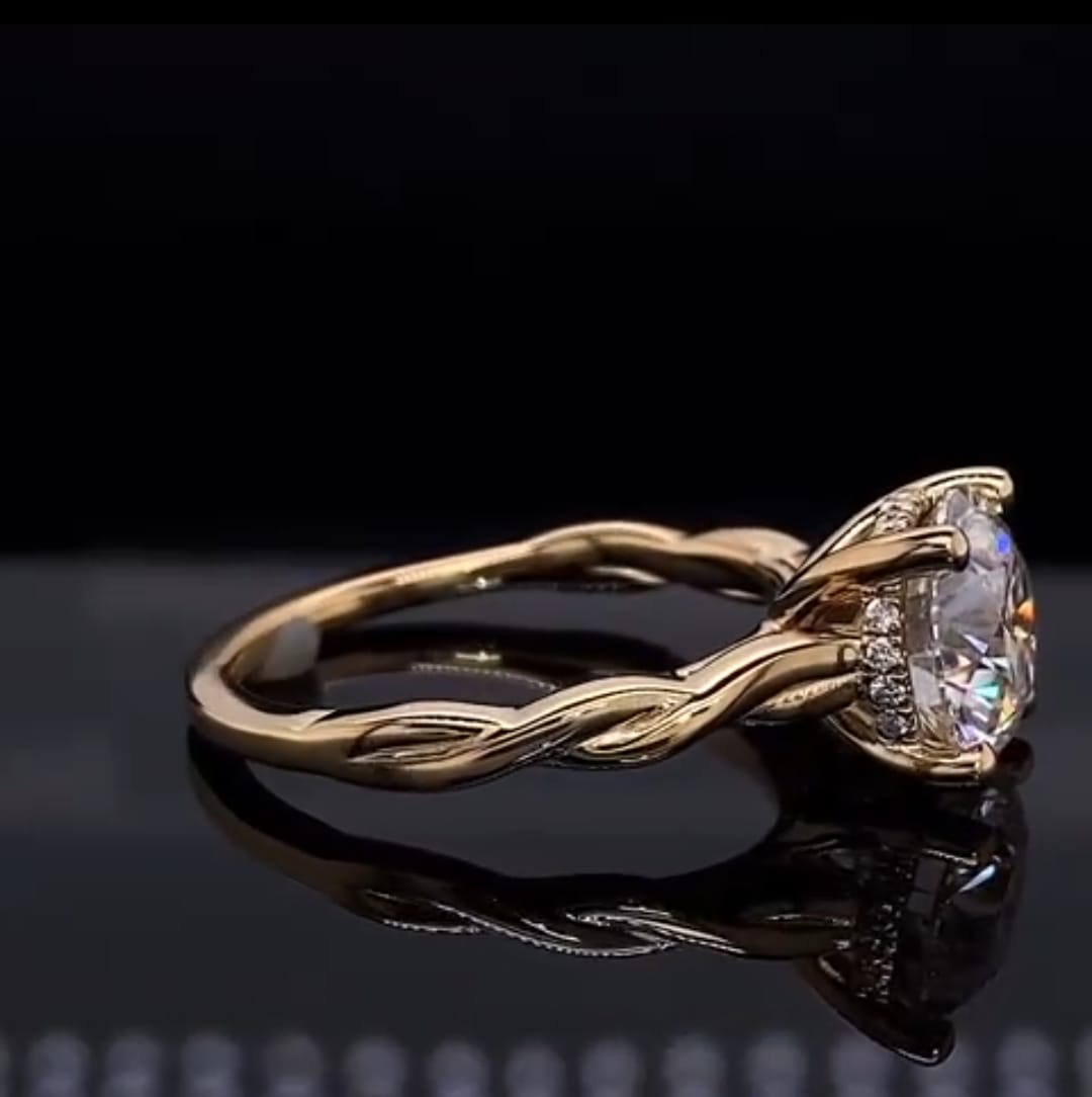 Side angle of a 2 CT round lab grown diamond ring showing the elegant intertwined yellow gold band design.