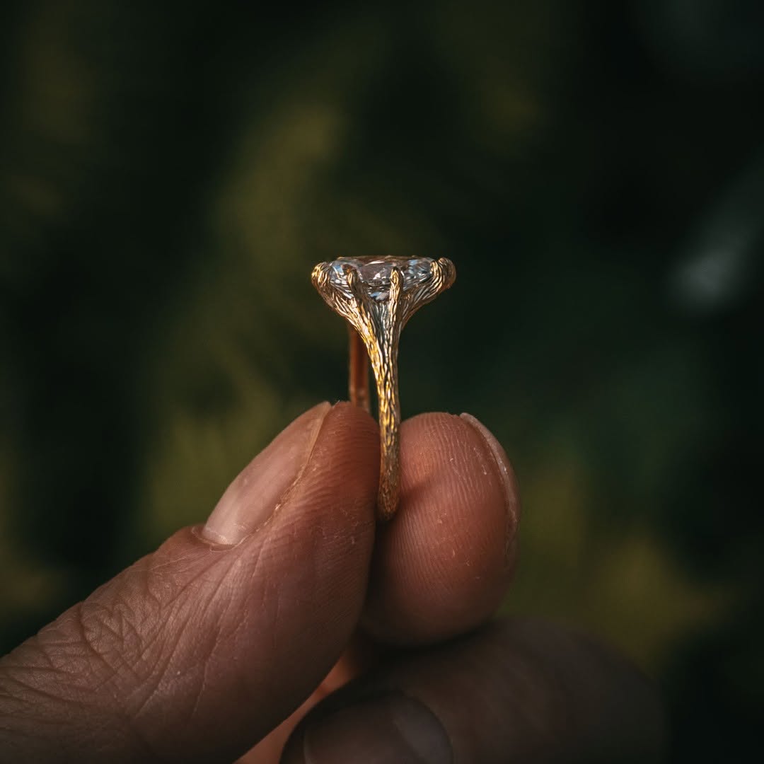 Side profile of a gold twig engagement ring setting, showcasing the height and brilliance of the 2 carat pear cut lab grown diamond.