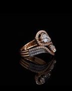 Angled side view of a Pear and Marquise cut lab grown diamond bypass ring with diamond halos, beautifully reflected on a black surface.
