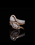 Top-down view of a stunning Toi et Moi ring featuring a pear and marquise lab diamond, both enclosed in sparkling halos on a black reflective background.