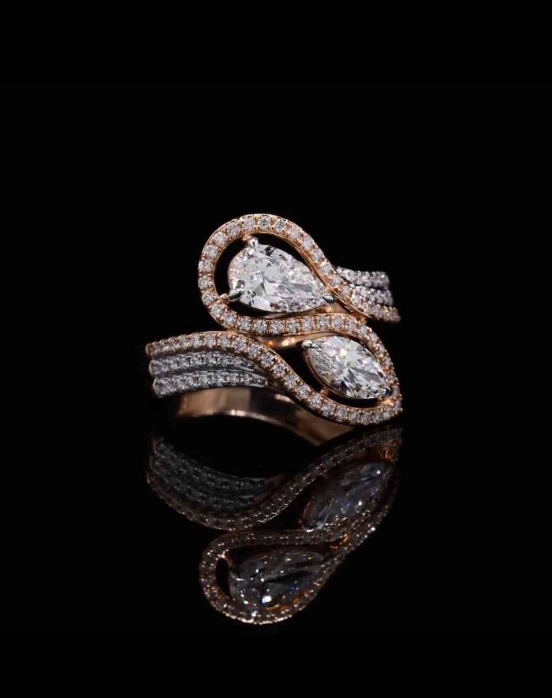 Striking front view of a Pear and Marquise Toi et Moi lab-created diamond ring with diamond-encrusted swirling bands.