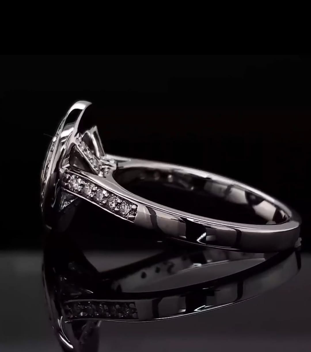 Side profile view of a white metal engagement ring showcasing the structured under-gallery and elevated bezel setting of a 3 ct oval lab diamond.