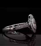 Profile view of a 3 CT oval lab diamond ring resting on a black surface, highlighting the brilliant pavé diamonds set along the ring's shoulders.