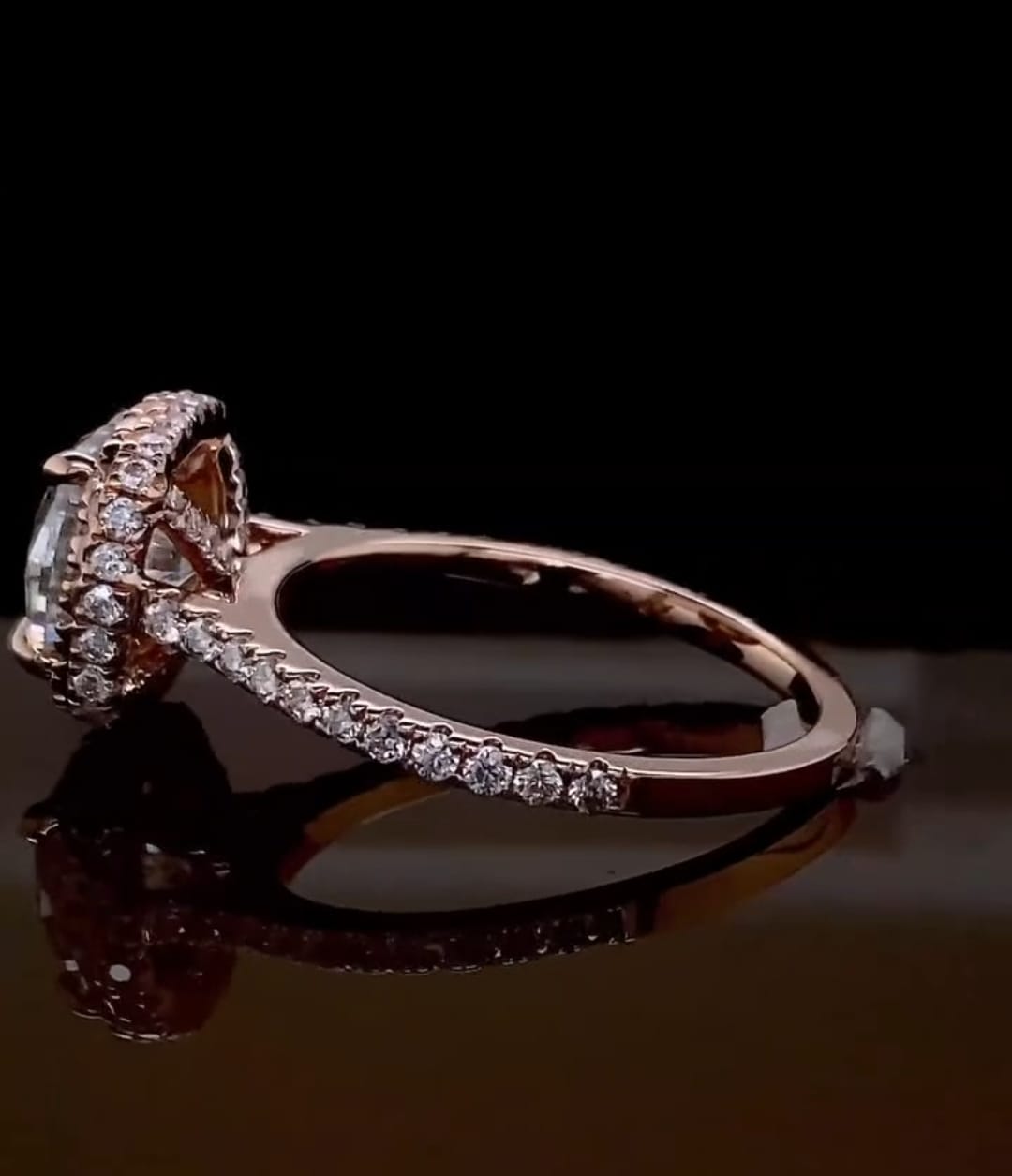Side profile view of a rose gold 2 carat cushion cut lab grown diamond ring with a halo and pavé band.