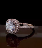 Angled view of a 2 carat cushion halo lab diamond ring showcasing the intricate basket setting and pavé rose gold band.