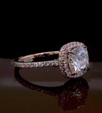 Side-angled view highlighting the sparkling diamond halo and rose gold prongs of a 2ct cushion cut lab diamond ring.