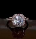 Direct front view of a stunning 2 carat cushion cut lab created diamond engagement ring with a matching diamond halo.
