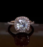 Direct front view of a stunning 2 carat cushion cut lab created diamond engagement ring with a matching diamond halo.