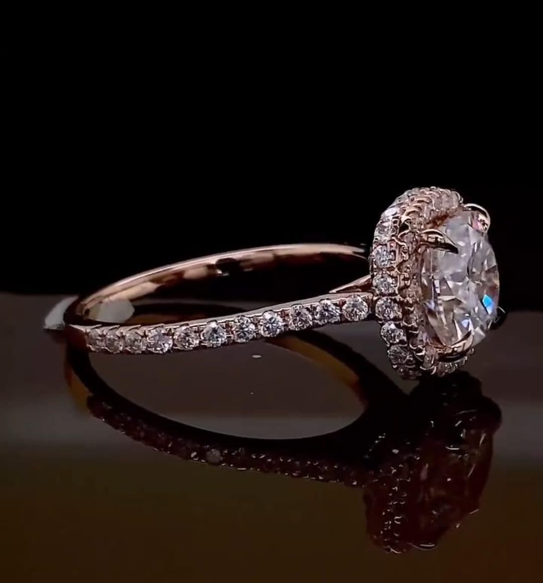 Low-angle side view of a rose gold cushion cut engagement ring showing the delicate pavé diamonds on the band.
