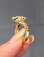 Side profile view of a marquise diamond ring setting showing the elevated gallery, prong details, and engraved gold shank.