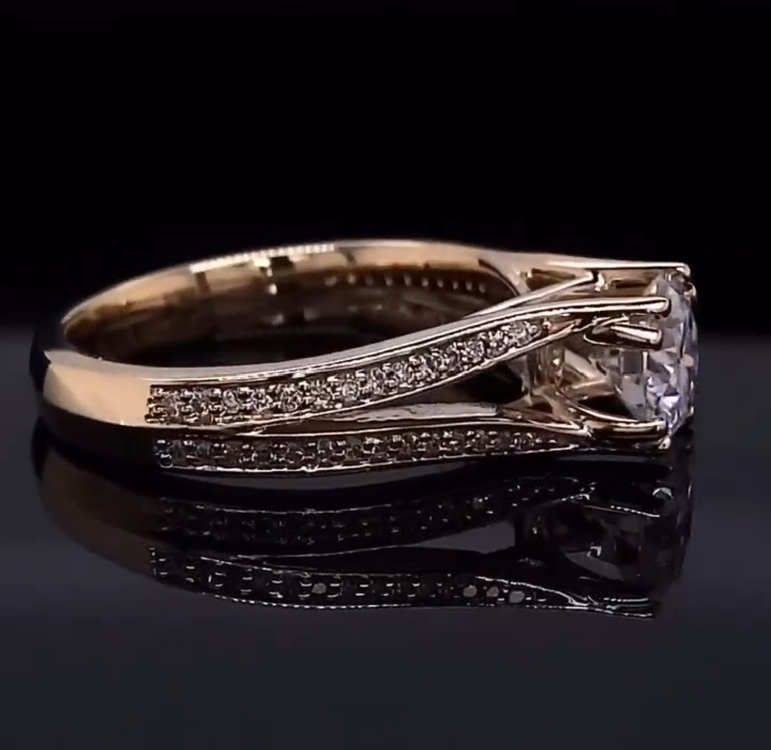 Side profile view of a round cut diamond engagement ring highlighting the polished metal band and sweeping pavé diamond accents.