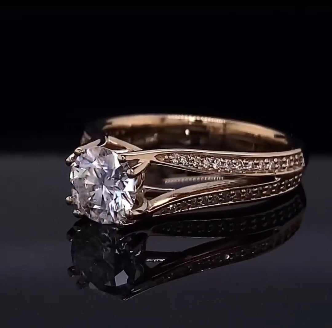 Three-quarter view of a sparkling 2 carat round diamond in a prong setting with a diamond-accented split shank band.