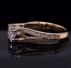 Close-up profile detailing the elegant sweep of the diamond-encrusted split shank converging at the center round diamond.