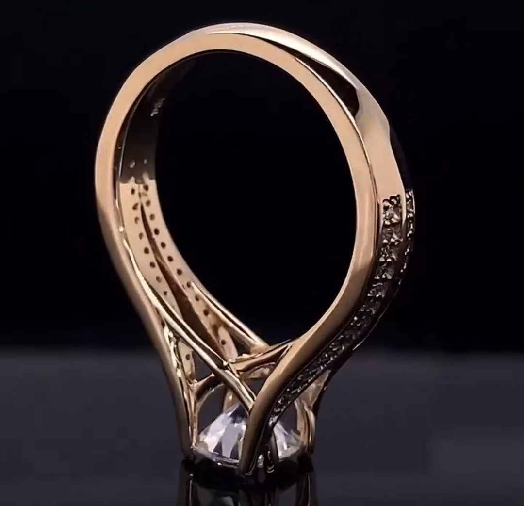 Angled lower view showing the architectural bridge and undercarriage of the twisted split shank diamond ring setting.