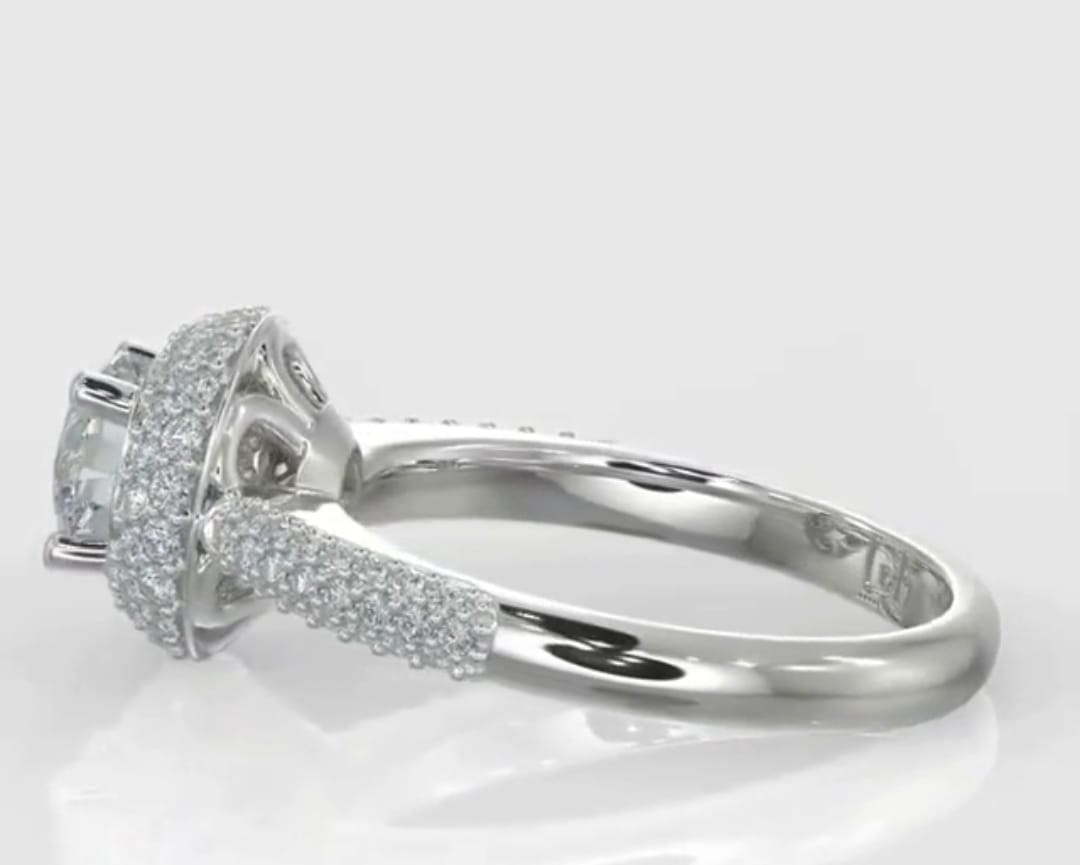 Side profile of a round diamond engagement ring featuring a thick micro-pavé halo and a multi-row diamond encrusted band.
